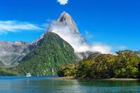 Famous Mitre Peak rising from the Milford Sound fiord and reflecting in water. Fiordland national park, New Zealand
