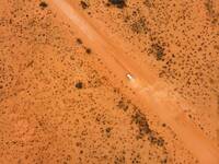 Drone shot of a camper van driving in the Australian Outback