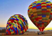 Hot air balloons being inflated at dawn in South Africa